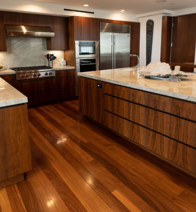a kitchen with all wood veneer cabinetry