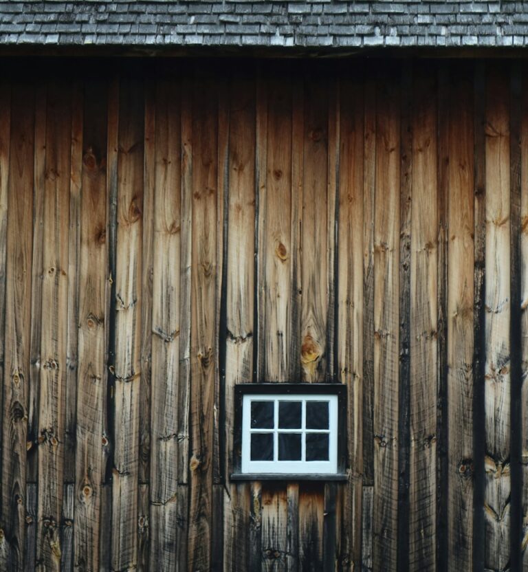 Weathered barnwood wall with a small window