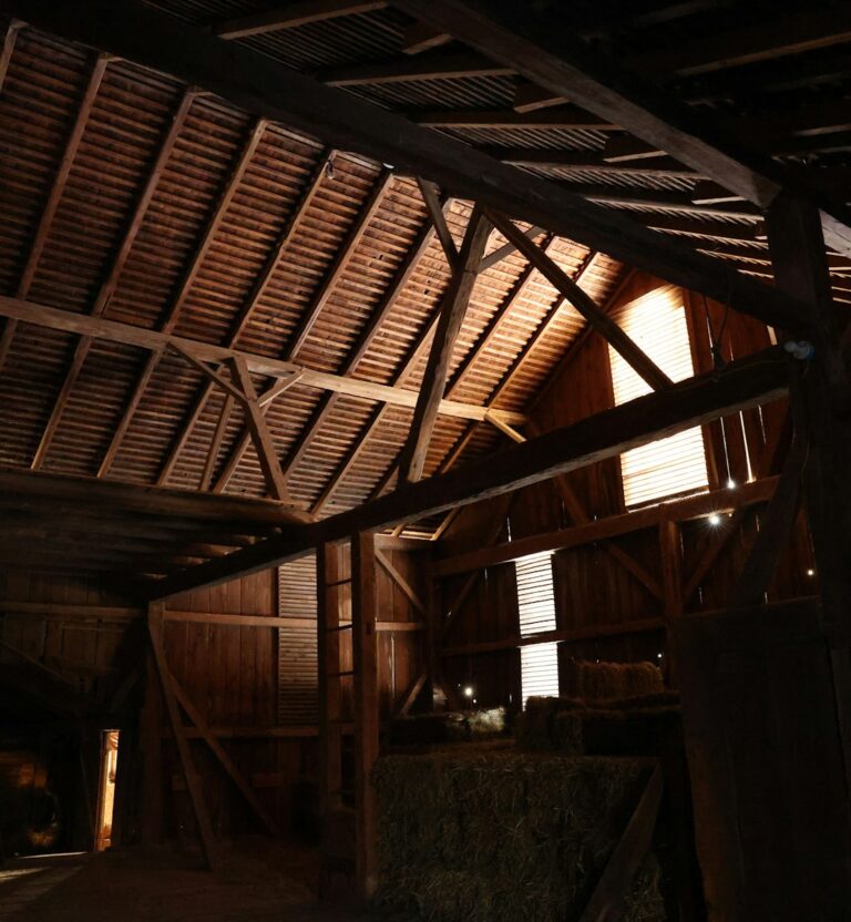 Interior of an old wooden barn with exposed beams
