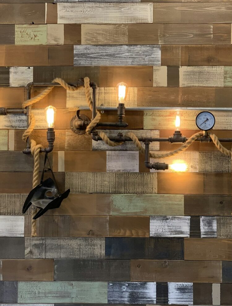 Reclaimed barnwood paneled wall with sconces Reclaimed barnwood paneled wall with sconces