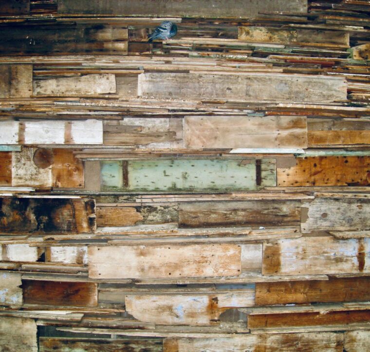 Stacked reclaimed barn planks in mixed colours