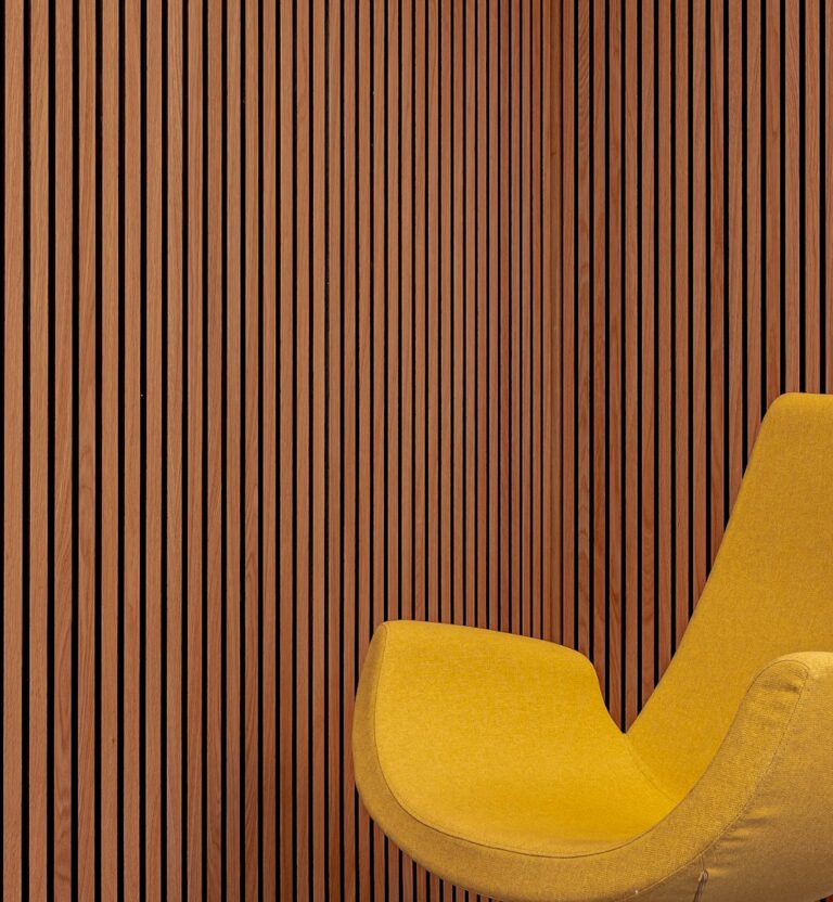 Warm wood slat wall behind a lounge chair