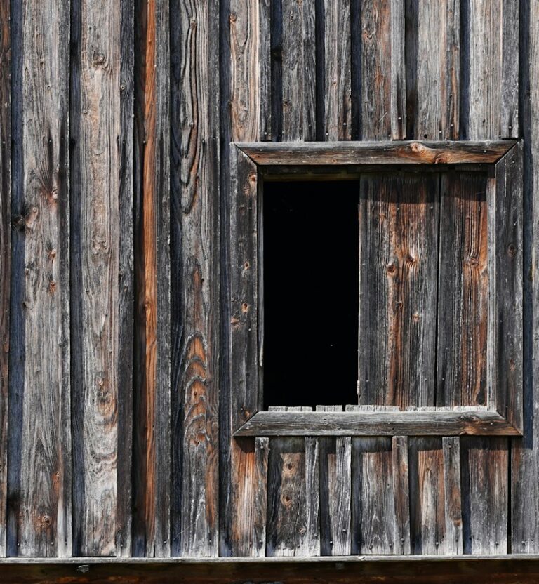 Weathered barn wall with a window opening