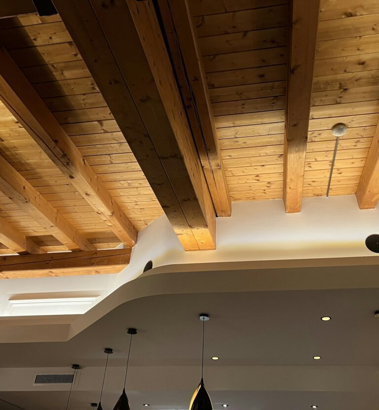 Wood plank ceiling with exposed beams